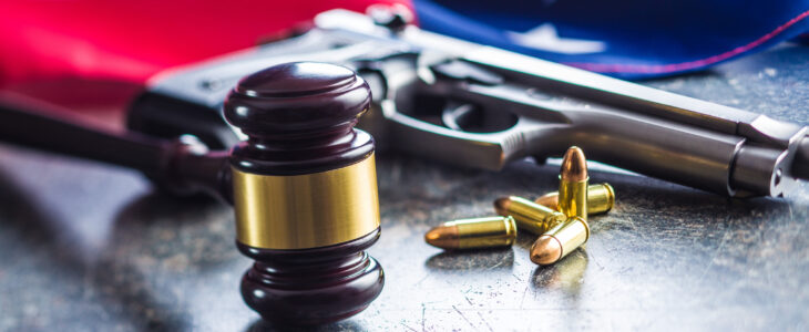 Judge gavel and gun bullets before usa flag