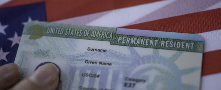 Permanent Resident Green card of United states of America on flag of USA