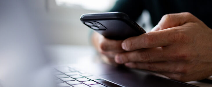 Focus on man hands typing message on phone